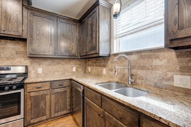 320 Collins St, Argyle, TX 76226 - kitchen featuring stainless steel appliances, a sink, decorative backsplash, range hood, and light stone countertops