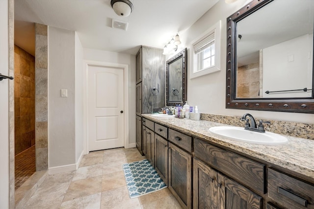 320 Collins St, Argyle, TX 76226 - bathroom featuring double vanity, baseboards, and tiled shower