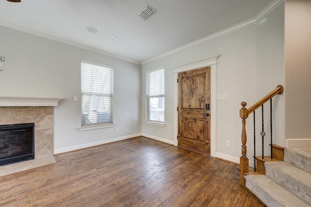 320 Collins St, Argyle, TX 76226 - foyer entrance featuring wood finished floors, stairs, crown molding, a tile fireplace, and baseboards