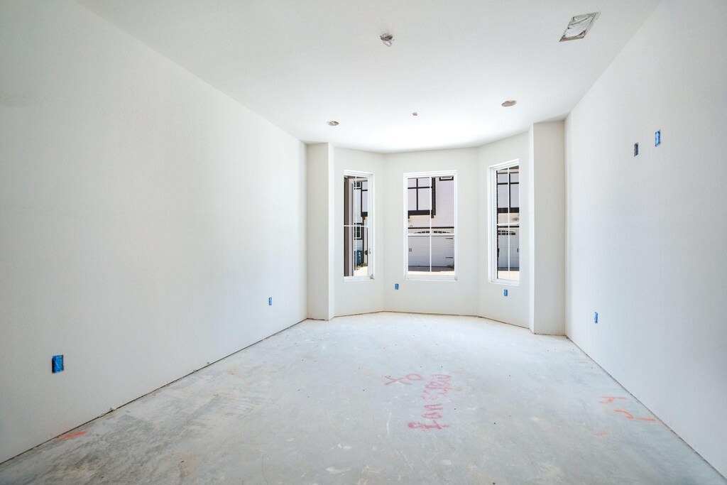 254 Harris St, Lewisville, TX 75057 - spare room featuring concrete floors