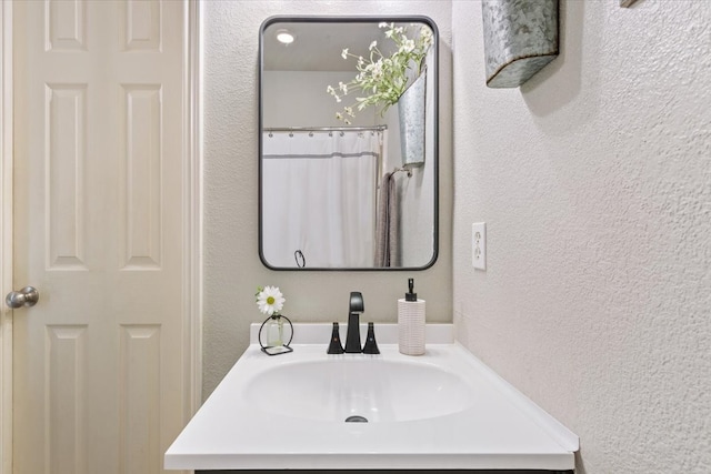 10285 Peony Ln, Waco, TX 76708 - bathroom featuring a textured wall and vanity