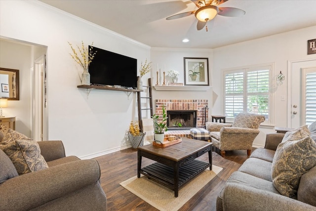 10285 Peony Ln, Waco, TX 76708 - living area with a ceiling fan, a brick fireplace, wood finished floors, crown molding, and baseboards