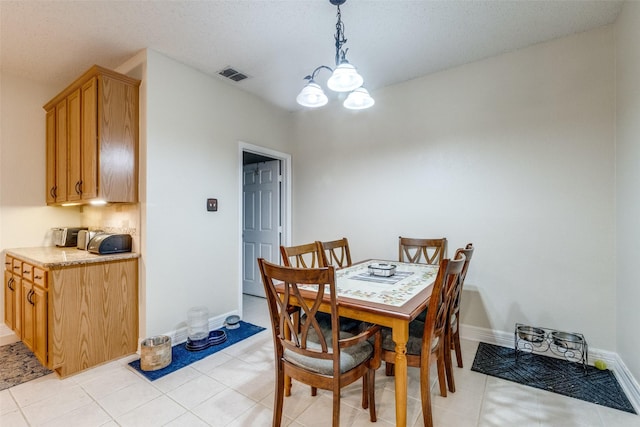 1109 Huntington Trl, Mansfield, TX 76063 - dining space with a chandelier, baseboards, light tile patterned floors, and a textured ceiling