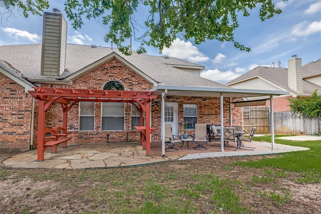1109 Huntington Trl, Mansfield, TX 76063 - rear view of property with brick siding, a pergola, roof with shingles, and a patio area