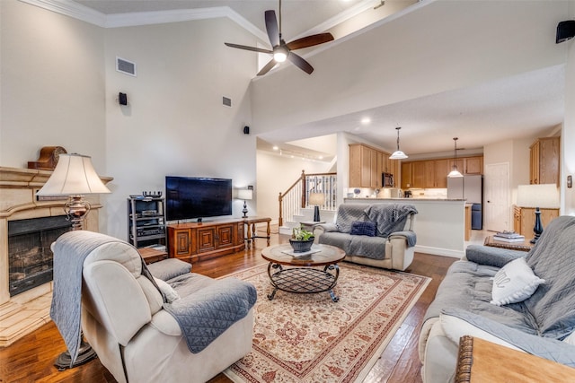1109 Huntington Trl, Mansfield, TX 76063 - living area with wood-type flooring, a high end fireplace, ornamental molding, vaulted ceiling, and recessed lighting