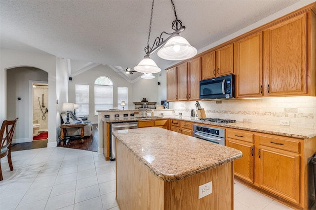 1109 Huntington Trl, Mansfield, TX 76063 - kitchen with appliances with stainless steel finishes, arched walkways, light tile patterned floors, a peninsula, and a textured ceiling