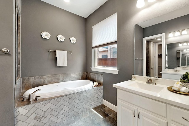 12164 Curry Creek Dr, Frisco, TX 75035 - full bathroom with a garden tub, vanity, and baseboards