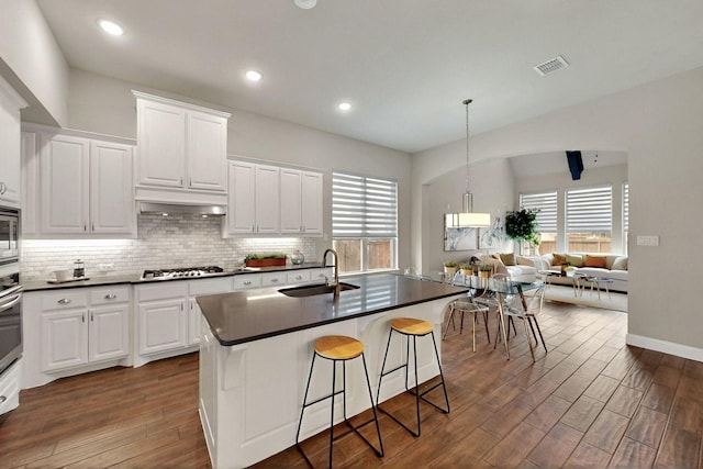 12164 Curry Creek Dr, Frisco, TX 75035 - kitchen featuring a sink, dark countertops, dark wood finished floors, decorative backsplash, and recessed lighting