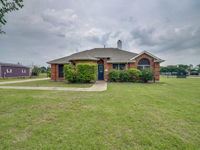 605 Lakeridge Dr, Lavon, TX 75166 - view of front of home with brick siding, a chimney, a front lawn, and a shingled roof