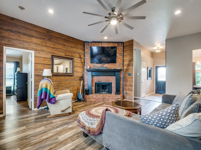 605 Lakeridge Dr, Lavon, TX 75166 - living room with ceiling fan, wood finished floors, a fireplace, wooden walls, and recessed lighting