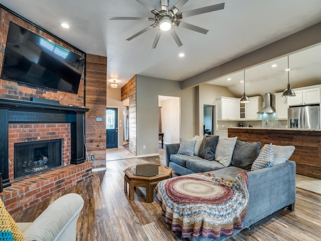 605 Lakeridge Dr, Lavon, TX 75166 - living area featuring wood finished floors, ceiling fan, lofted ceiling, recessed lighting, and a fireplace