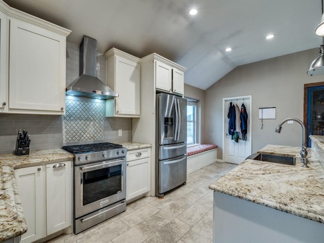 605 Lakeridge Dr, Lavon, TX 75166 - kitchen with appliances with stainless steel finishes, wall chimney exhaust hood, lofted ceiling, a sink, and tasteful backsplash