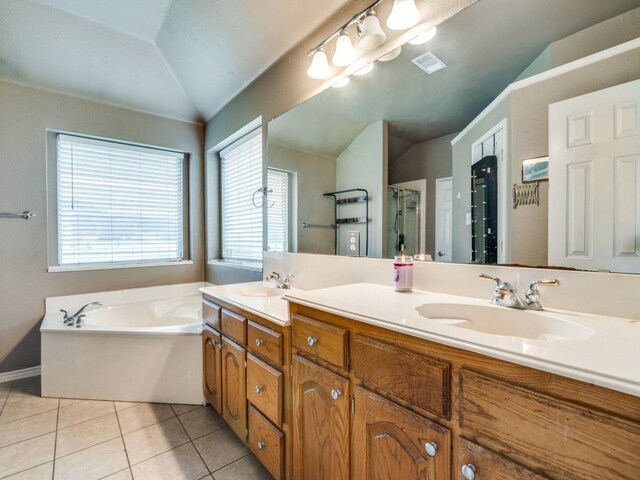 605 Lakeridge Dr, Lavon, TX 75166 - bathroom with lofted ceiling, a shower stall, tile patterned floors, a bath, and double vanity