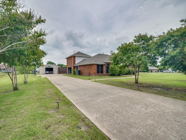 605 Lakeridge Dr, Lavon, TX 75166 - view of front of home featuring driveway, a front lawn, brick siding, and a detached garage