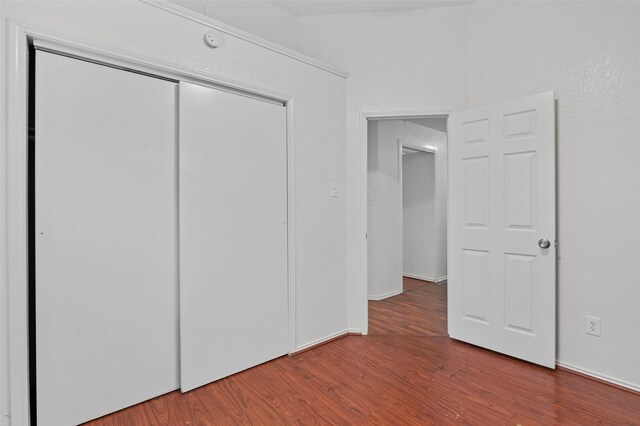 2323 Weatherby Dr, Mesquite, TX 75181 - unfurnished bedroom featuring wood finished floors, a closet, and baseboards