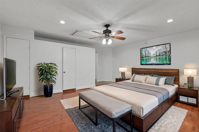 2323 Weatherby Dr, Mesquite, TX 75181 - bedroom featuring attic access, light wood-style flooring, a textured ceiling, recessed lighting, and ceiling fan