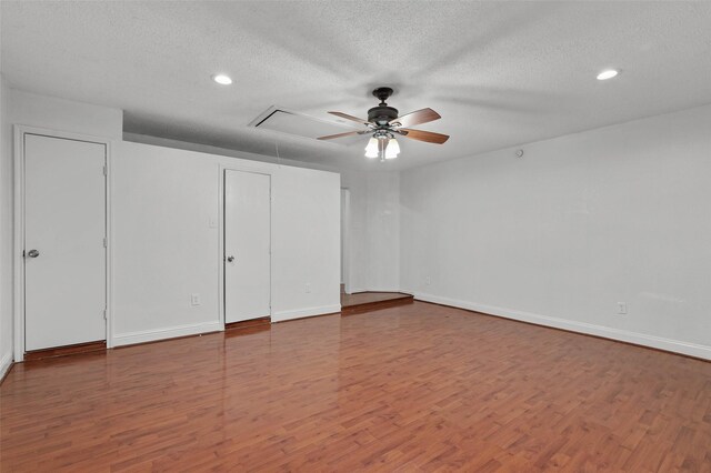 2323 Weatherby Dr, Mesquite, TX 75181 - unfurnished bedroom with attic access, wood finished floors, a textured ceiling, recessed lighting, and baseboards