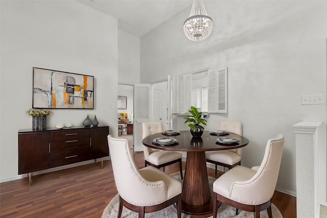 2323 Weatherby Dr, Mesquite, TX 75181 - dining room featuring a towering ceiling, dark wood-style flooring, a chandelier, and baseboards