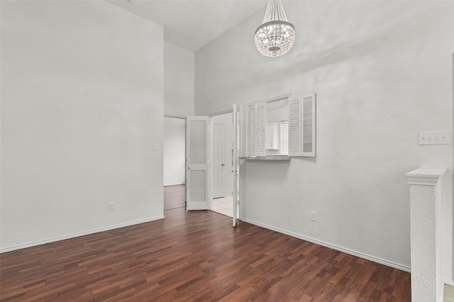 2323 Weatherby Dr, Mesquite, TX 75181 - unfurnished room with a high ceiling, a chandelier, wood finished floors, and baseboards