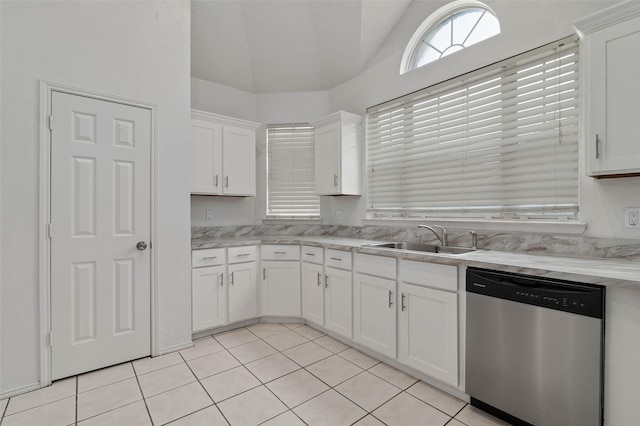 2323 Weatherby Dr, Mesquite, TX 75181 - kitchen with stainless steel dishwasher, a sink, lofted ceiling, white cabinets, and light tile patterned floors