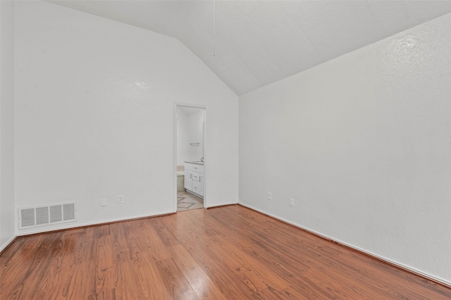 2323 Weatherby Dr, Mesquite, TX 75181 - spare room featuring wood finished floors, vaulted ceiling, and baseboards