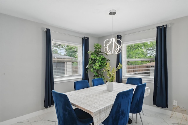 1632 Pecan Park Dr, Arlington, TX 76012 - dining area featuring light marble finish floors, a chandelier, and baseboards