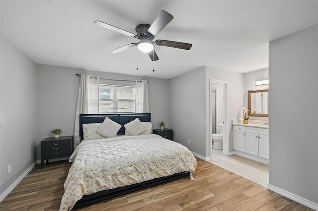 1632 Pecan Park Dr, Arlington, TX 76012 - bedroom featuring light wood finished floors, ensuite bathroom, baseboards, and a ceiling fan