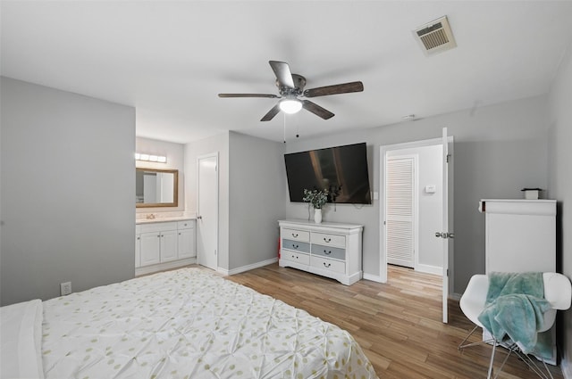 1632 Pecan Park Dr, Arlington, TX 76012 - bedroom featuring light wood-type flooring, baseboards, ceiling fan, and ensuite bath