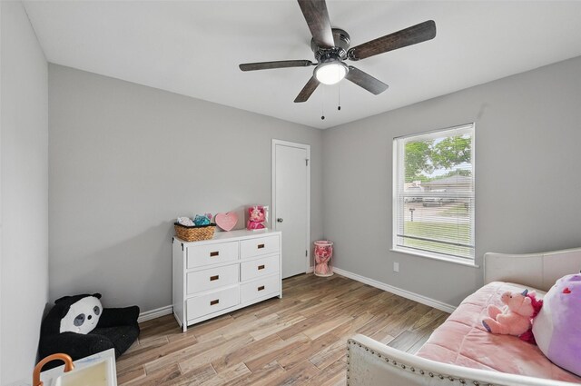 1632 Pecan Park Dr, Arlington, TX 76012 - bedroom with light wood finished floors, baseboards, and a ceiling fan