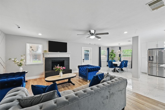 1632 Pecan Park Dr, Arlington, TX 76012 - living room with recessed lighting, a ceiling fan, baseboards, light wood-style floors, and a fireplace