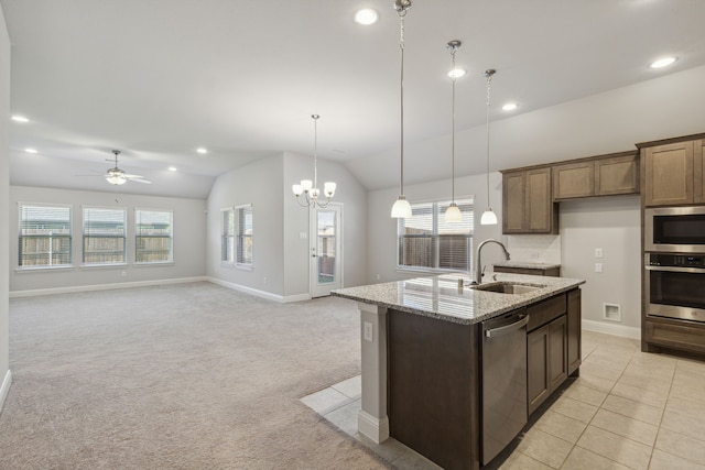 548 Bradley Dr, Fate, TX 75087 - kitchen featuring stainless steel appliances, a sink, light stone counters, vaulted ceiling, and pendant lighting