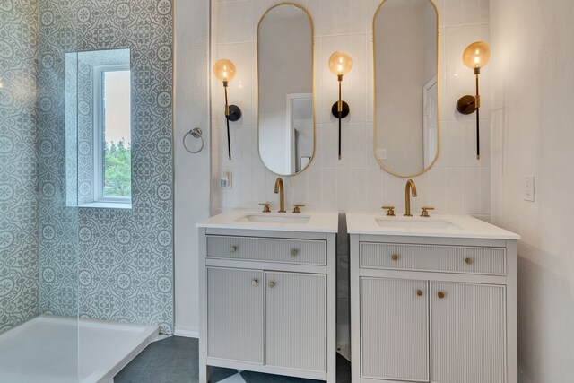 10721 Emerald Park Ln, Fort Worth, TX 76052 - bathroom featuring two vanities and a tile shower