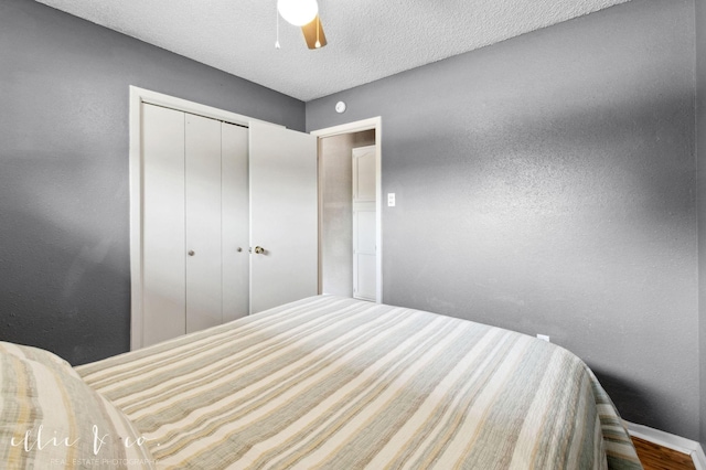 3718 Radcliff Rd, Abilene, TX 79602 - bedroom with ceiling fan, a closet, a textured ceiling, baseboards, and a textured wall
