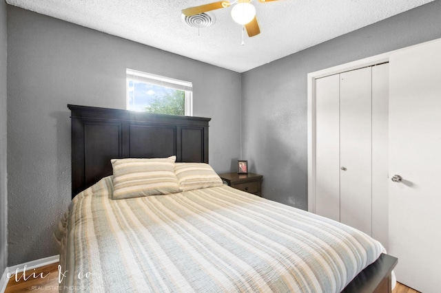 3718 Radcliff Rd, Abilene, TX 79602 - bedroom with a closet, wood finished floors, a ceiling fan, baseboards, and a textured ceiling