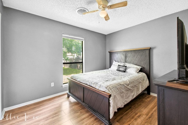 3718 Radcliff Rd, Abilene, TX 79602 - bedroom with wood finished floors, a textured ceiling, ceiling fan, and baseboards