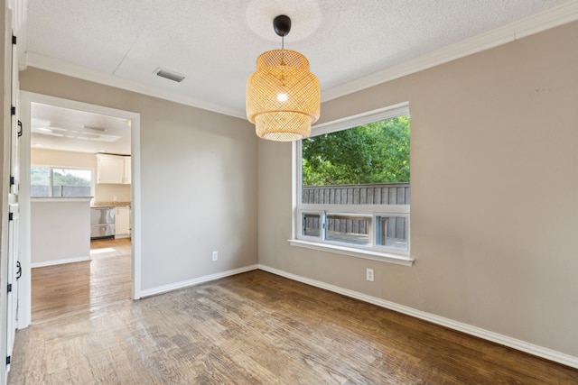 15741 Mapleview Cir, Dallas, TX 75248 - empty room with wood finished floors, a textured ceiling, crown molding, and baseboards