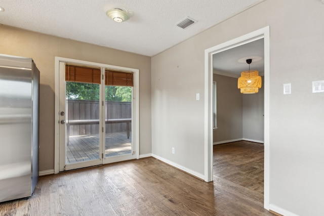 15741 Mapleview Cir, Dallas, TX 75248 - unfurnished dining area featuring wood finished floors, baseboards, and a textured ceiling