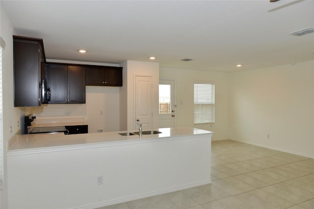 5532 Timber Point Dr, Princeton, TX 75407 - kitchen with stove, black microwave, a sink, a peninsula, and light countertops