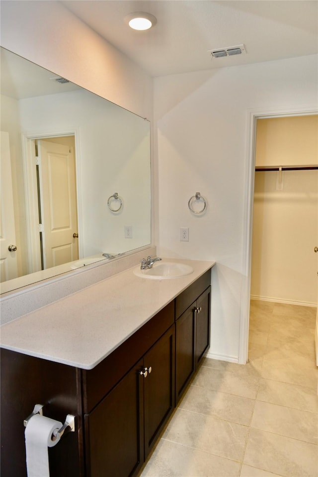 5532 Timber Point Dr, Princeton, TX 75407 - bathroom featuring vanity, tile patterned flooring, a walk in closet, and baseboards