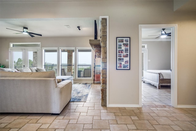 101 Eagle Pt, Graford, TX 76449 - living room with ceiling fan, stone tile flooring, and baseboards