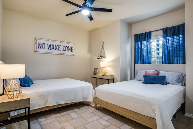 101 Eagle Pt, Graford, TX 76449 - bedroom with stone finish floors and a ceiling fan
