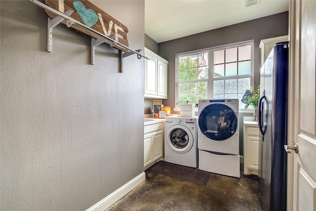 1116 Squaw Vly, Rockwall, TX 75087 - laundry area featuring cabinet space, washing machine and dryer, baseboards, and a textured wall