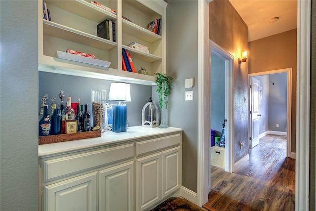 1116 Squaw Vly, Rockwall, TX 75087 - bar featuring dark wood-type flooring and baseboards