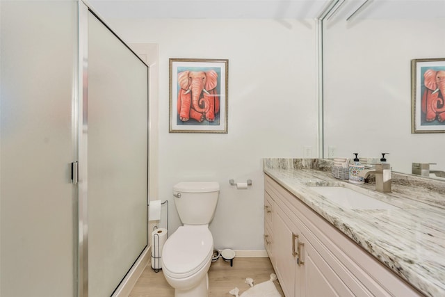 3904 Crescent Dr, De Cordova, TX 76049 - bathroom featuring baseboards, toilet, wood finished floors, vanity, and a stall shower