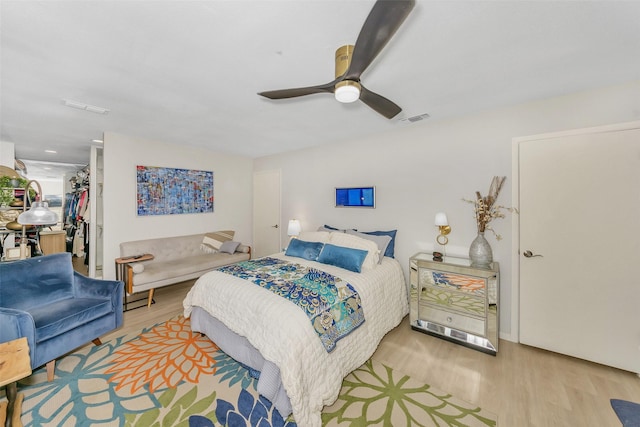 3904 Crescent Dr, De Cordova, TX 76049 - bedroom featuring wood finished floors, a walk in closet, a closet, and ceiling fan