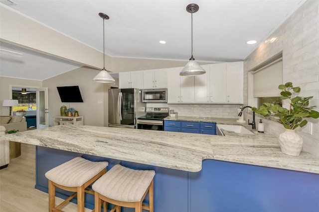 3904 Crescent Dr, De Cordova, TX 76049 - kitchen featuring stainless steel appliances, a sink, vaulted ceiling, white cabinets, and light stone counters