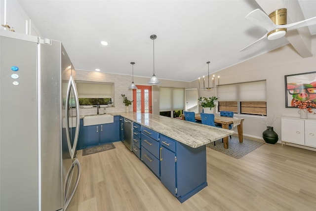 3904 Crescent Dr, De Cordova, TX 76049 - kitchen featuring appliances with stainless steel finishes, blue cabinets, a sink, light wood-type flooring, and vaulted ceiling