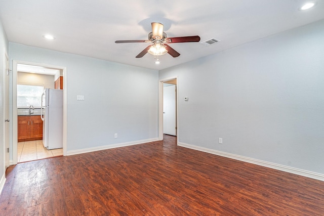 8830 Boundbrook Ave, Dallas, TX 75243 - empty room with ceiling fan, light wood-style flooring, baseboards, a sink, and recessed lighting