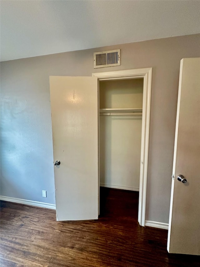 2952 Eric Ln, Farmers Branch, TX 75234 - unfurnished bedroom with wood finished floors, a closet, and baseboards