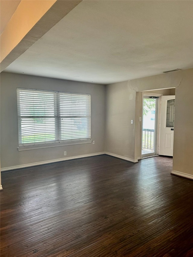 2952 Eric Ln, Farmers Branch, TX 75234 - spare room featuring dark wood-style flooring and baseboards